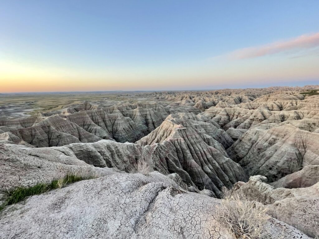 Pastel colors across landscape during sunrise at Big Badlands Overlook