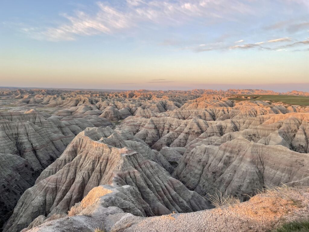 Pastel colors across landscape during sunrise at Big Badlands Overlook