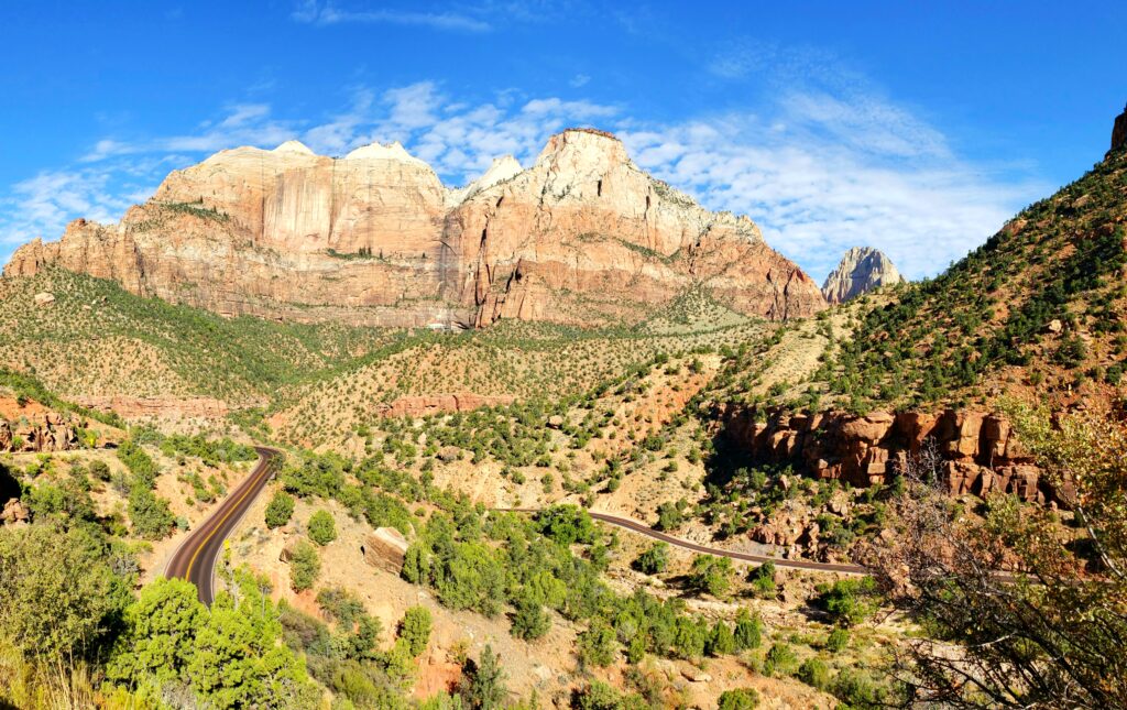 Overlooking windy roads with mountains in Zion National Park and blue sky