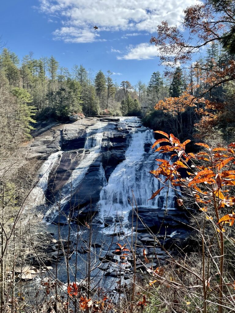 High Falls waterfall with foliage and blue sky