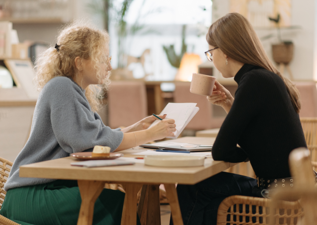 Couple sitting at table drinking coffee and reviewing information