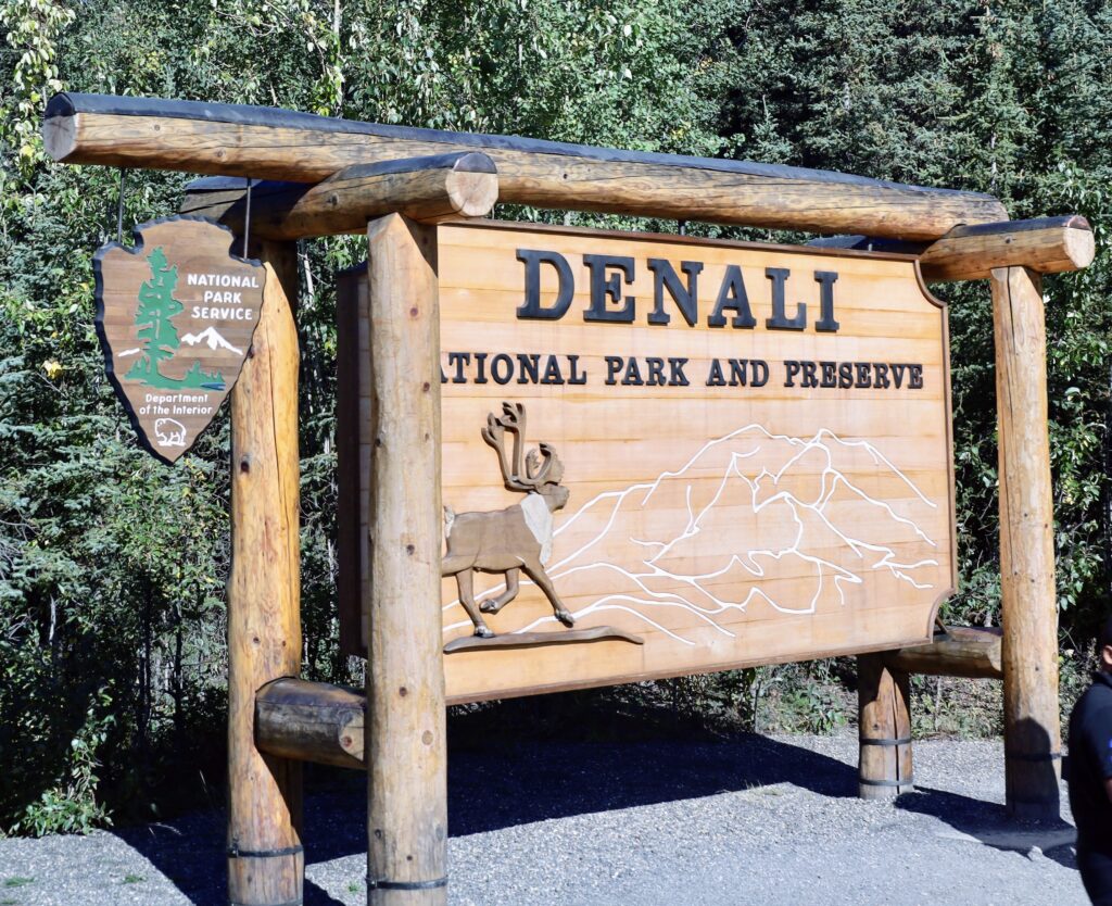 Picture of Denali National Park & Preserve wooden sign with green trees in background