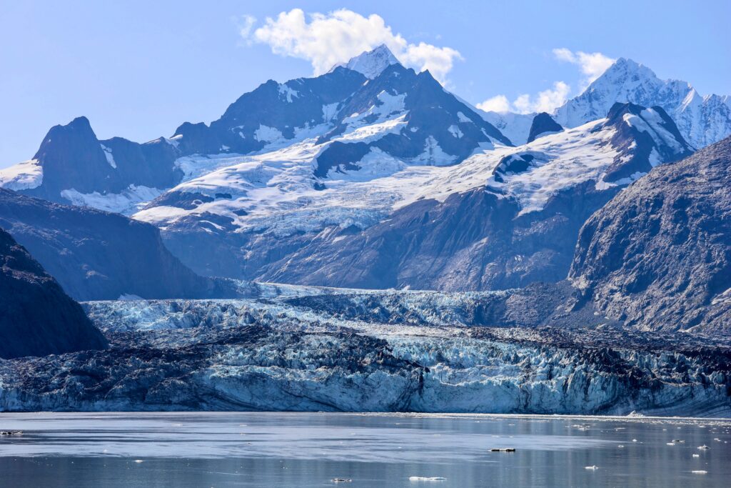 Johns Hopkins glacier from the water with dramatic snow capped mountains in the background