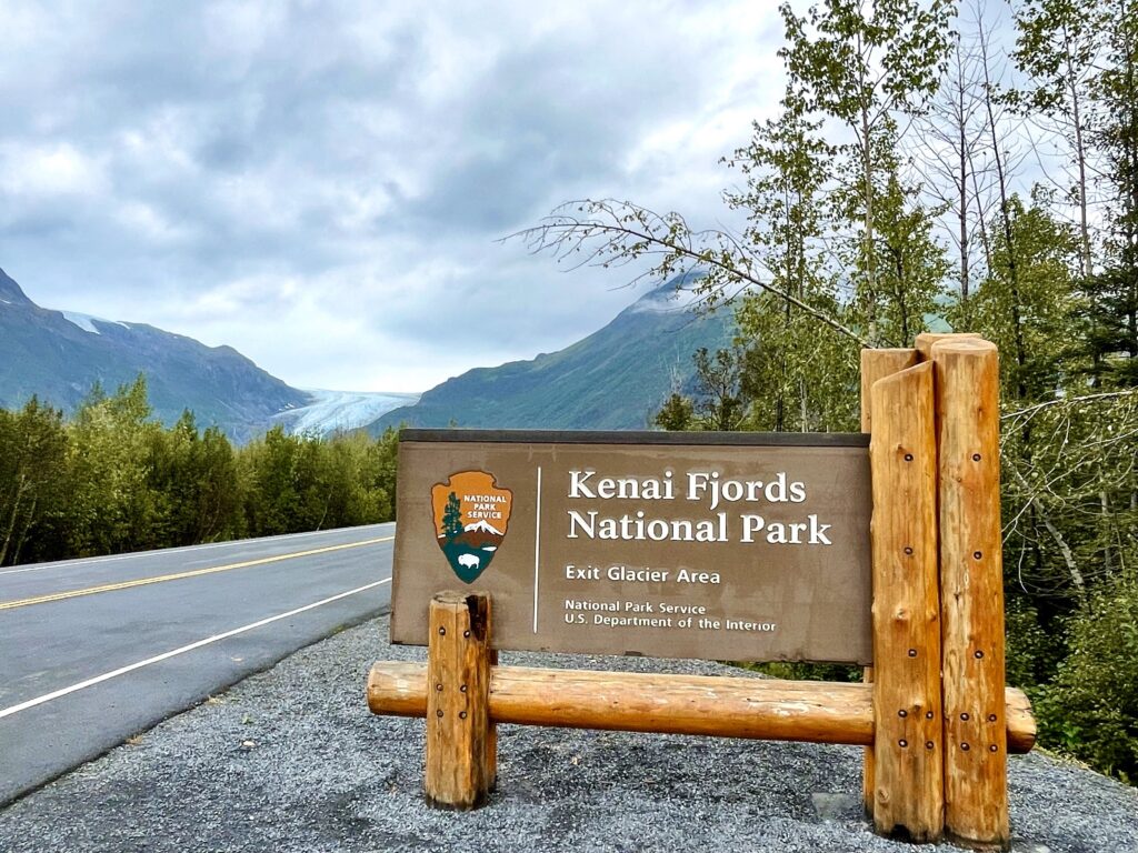 Kenai Fjords national park sign with Exit Glacier and a road